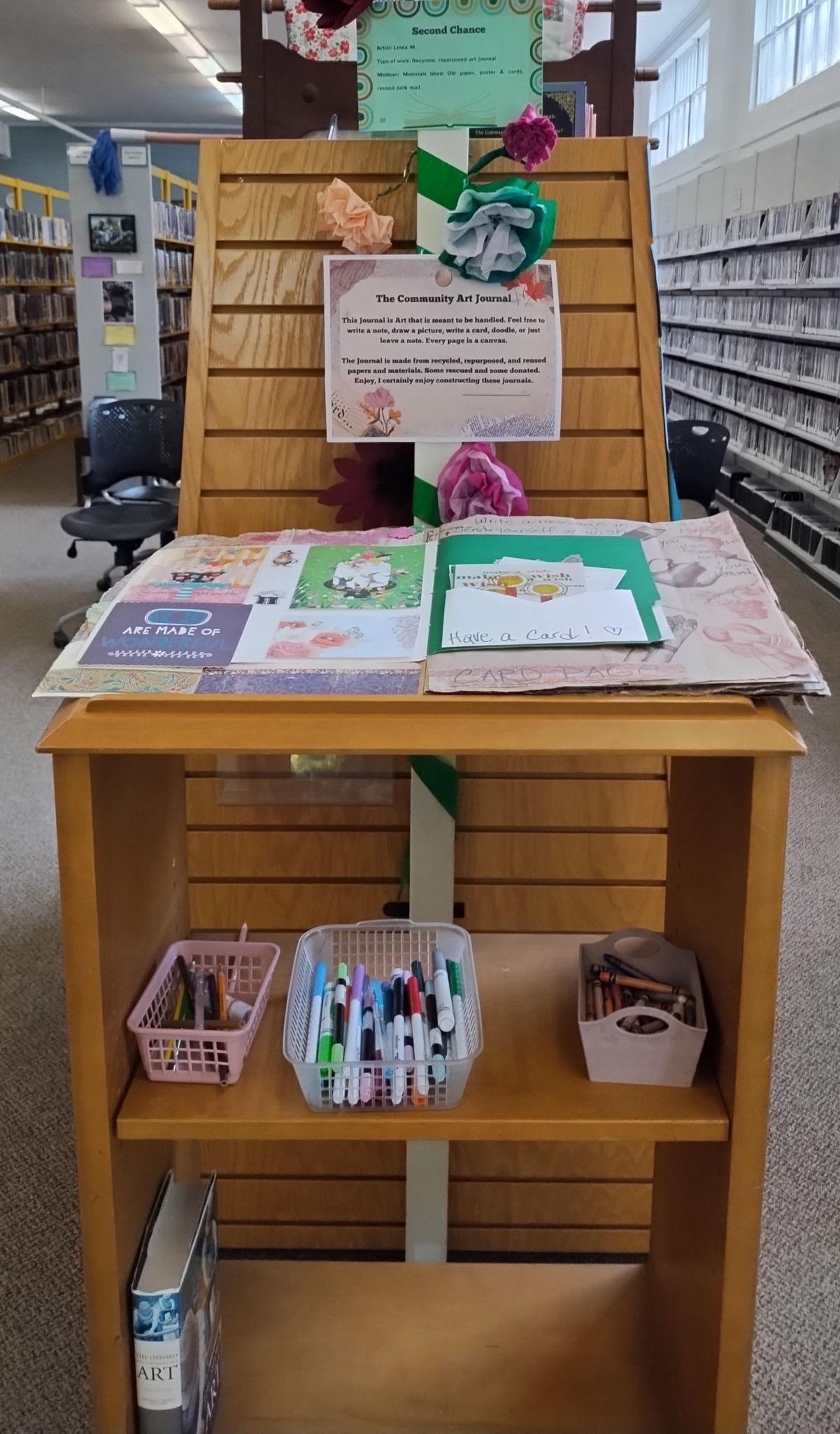 Colorful mixed-media collage featuring the words 'Summer at the Library' and decorative motifs