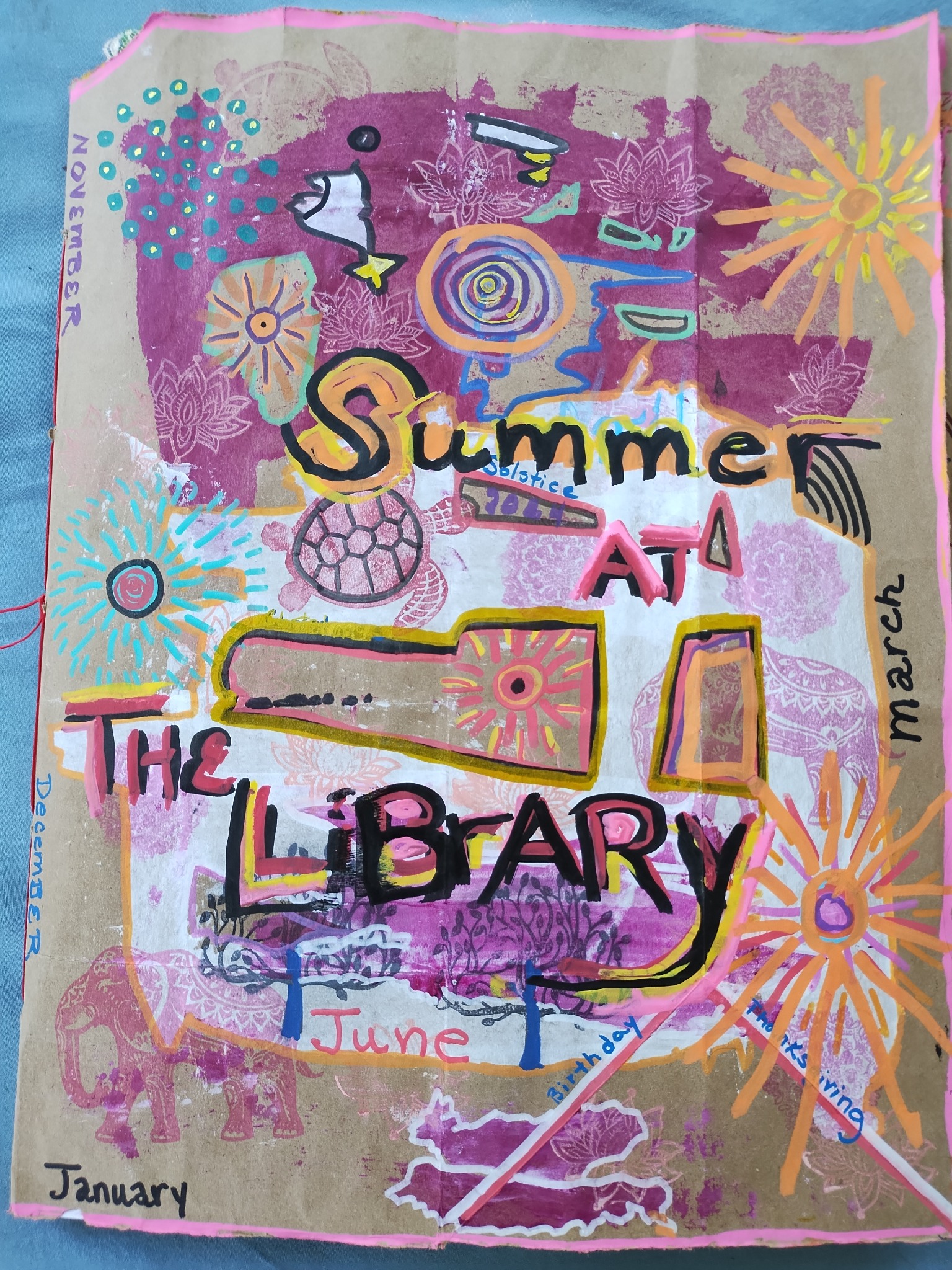 Colorful mixed-media collage featuring the words 'Summer at the Library' and decorative motifs